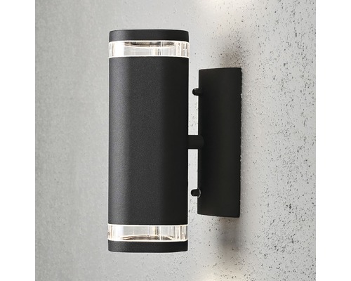 Svart vägglampa för utomhusbruk med cylindrisk design.