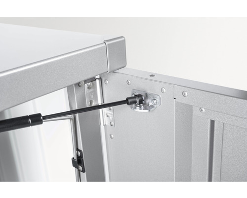 Detaljvy av ett öppet skåp med gasfjäder