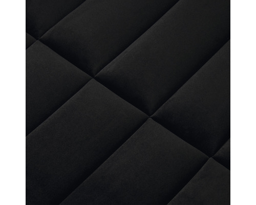 Detaljbild av ett quiltat tyg med diamantmönster