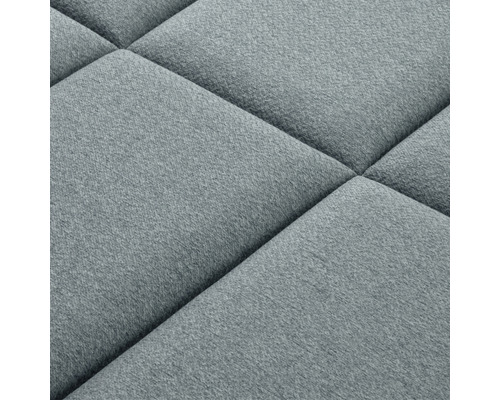 Närbild av en vadderad väggpanel med kvadratiskt mönster