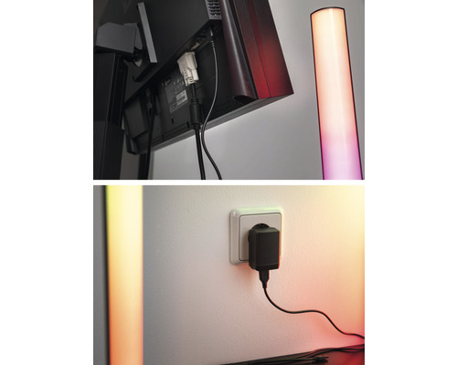 Detaljbild av en bildskärm med kabelanslutningar och en golvlampa samt en strömförsörjningsenhet i ett uttag