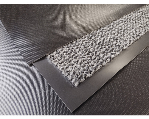 Närbild av en entrématta med textilyta och kant