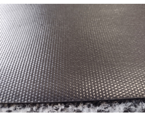 Närbild av en svart halkskyddsmatta med noppstruktur