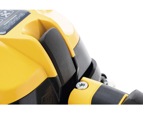 Närbild av en gul enhet med svart spak och bruksanvisning.