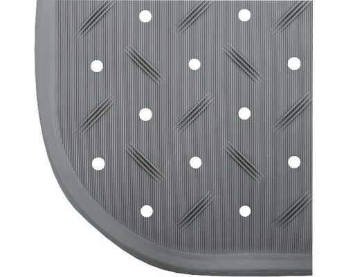 Detalj av en duschmatta med hål och ribbad yta