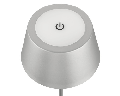 Närbild av en grå bordslampa med på/av-symbol