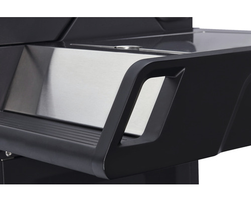 Detaljvy av sidobordet på en grill med rostfri plåt