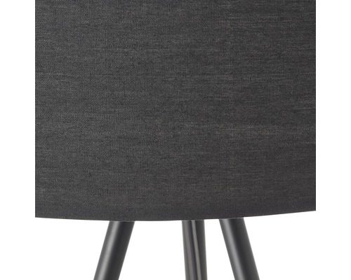 Detalj av en golvlampa med tygskärm och lampfot