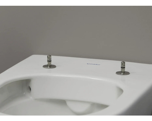 Detaljvy av en vit Duravit toalett med fästbultar