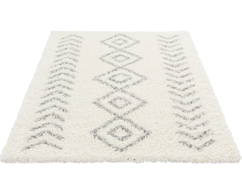 Vit matta med romb- och pilmönster