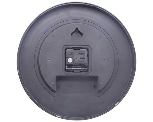 Baksidan av en rund väggklocka med kvartsurverk