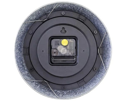 Baksidan av en rund väggklocka med metallram och urverk