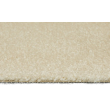 Närbild av en beige matta med kort lugg