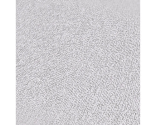 Närbild av en ljus non-woven tapet med en fin struktur