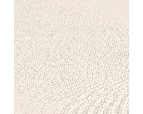 Närbild av ljus textilyta med fin struktur