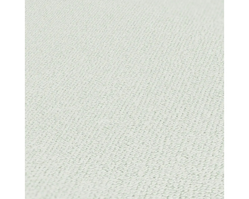 Närbild av en ljus textilvägg med fin struktur