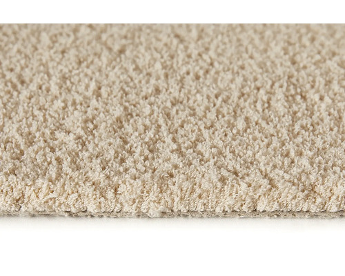 Närbild av en beige matta med öglad struktur