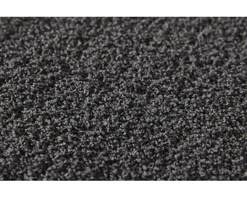 Närbild av en grå matta med hög lugg