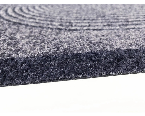 Detaljvy av en rund matta med koncentriskt mönster