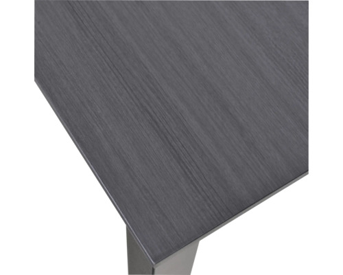 Detaljvy av en bordsskiva med trästruktur och bordsben