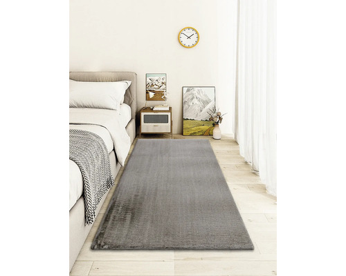 Grå matta i ett sovrum med säng och sidobord