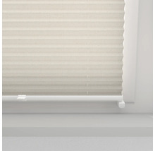 Beige plisségardin på ett fönster