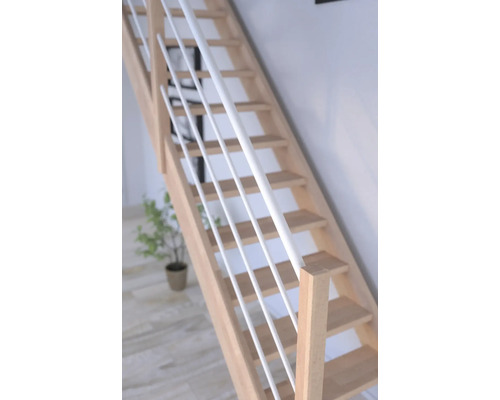 Trätrappa med vita räckesståndare i ett ljust rum