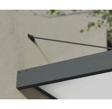 Detaljvy av ett grått entrétak på en husvägg.