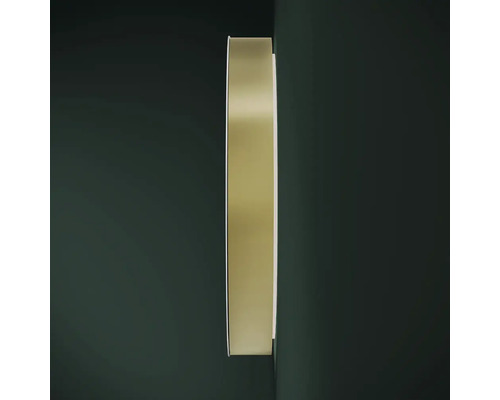 Rund spegel med metallram på väggen