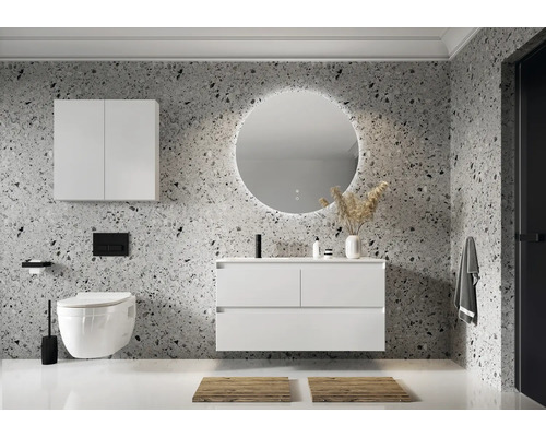 Modernt badrum med tvättställ, spegelskåp, rund spegel med belysning och hängande toalett