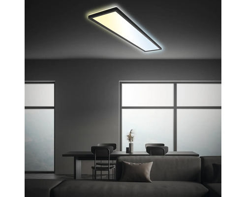 Modernt vardagsrum med rektangulär taklampa och matbord