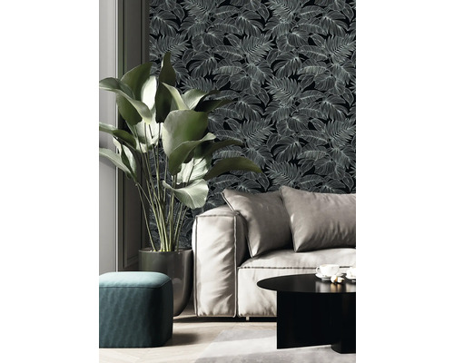 Vardagsrum med soffa, krukväxt och blommig tapet