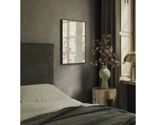 Sovrum med säng, nattduksbord och inramad bild på väggen