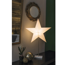 Dekorativt arrangemang med stjärnlampa, speglar och ornament på ett bord