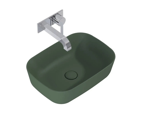 Bänkskiva handfat i grönt med väggmonterad metallkran