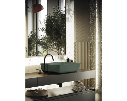 Modernt badrum med handfat, armatur och handdukar på hyllan