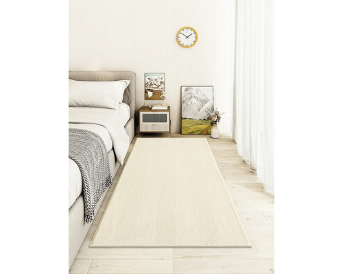 Sovrum med säng, sängbord och en mönstrad matta