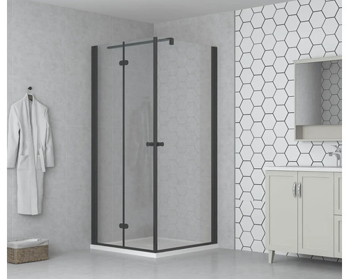 Badrum med duschkabin med svängdörr, tvättställ och hexagonala plattor