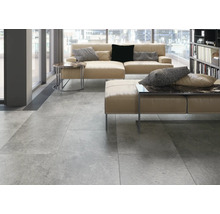 Ljust vardagsrum med klinkergolv, soffa och soffbord.