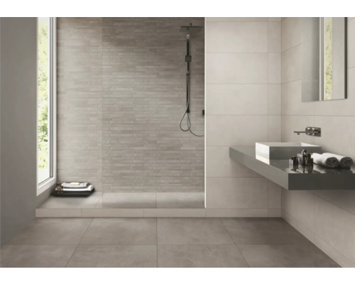 Modernt badrum med duschkabin, tvättställ och kakel