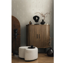 Interiörscen med beige tapet, träskåp, skulpturer och sittpuff