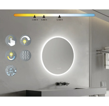Rund spegel med LED-belysning på en badrumsvägg med handfat och armatur samt symboler för funktioner.