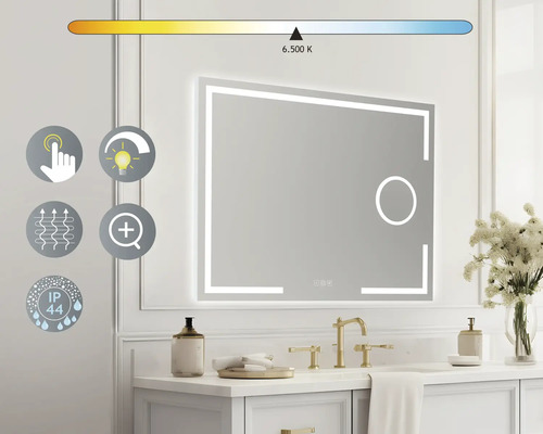 "Belyst spegel ovanför ett handfat med gyllene armatur och dekoration