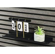 Dekorativ hylla med evighetskalender och konstgjord växt