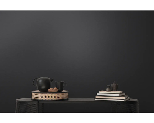 Dekorativ scen med tekanna, kopp och böcker på ett bord