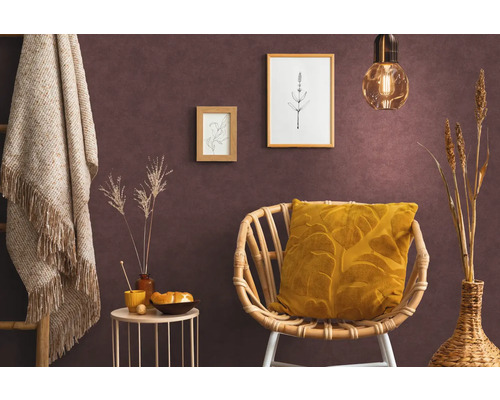 Vardagsrum med rottingfåtölj, kudde, sidobord, dekoration och väggmålningar