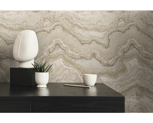 Dekorativt arrangemang med non-woven tapet i marmorlook, skulptur, växt och skål på ett bord