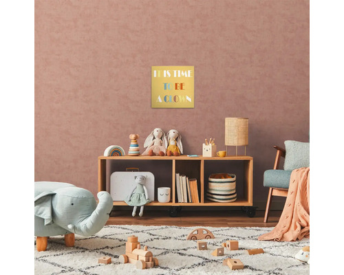 Barnrum med trähylla, leksaker och en inramad bild med texten ''It is time to be a clown''.