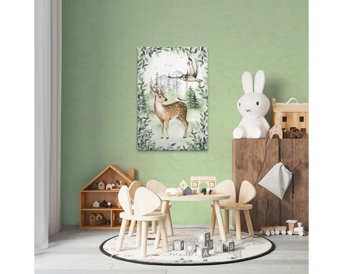 Barnrum med träbord, stolar, leksaker och en väggmålning av en hjort och en uggla