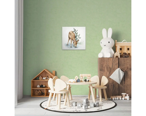 Dekorativt barnrum med en hjortmålning på väggen, ett bord med stolar och leksaker.